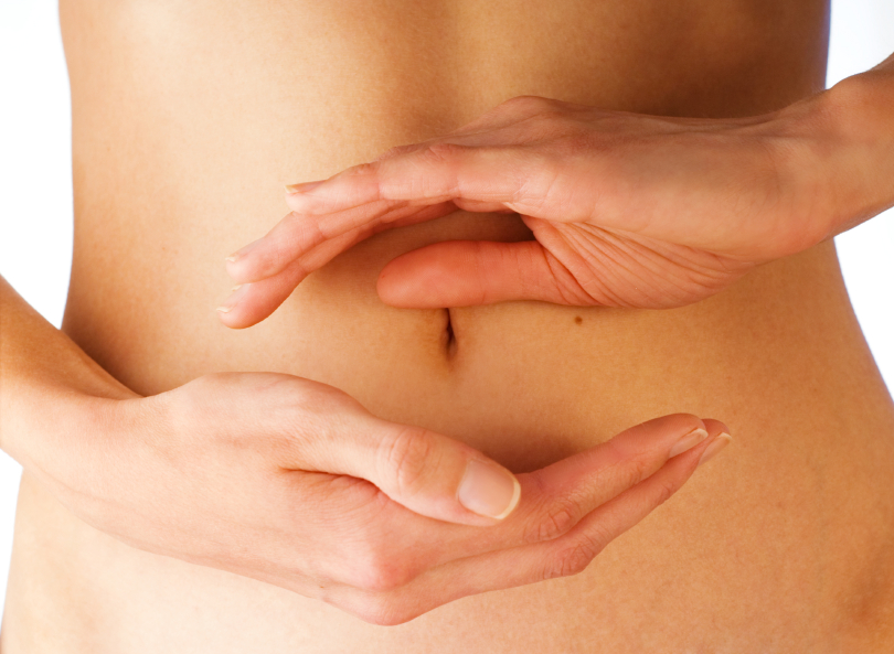 women holding her hands in circle shape in front of her stomach